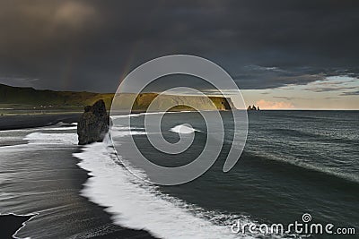 Black Sand Beach Reynisfjara in Iceland. Windy Morning. Ocean Waves. Colorful Sky Stock Photo