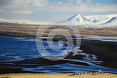 Black sand beach and snow moutains in Iceland Stock Photo