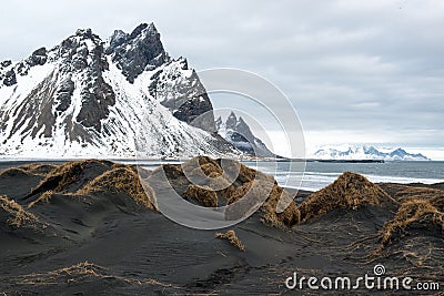 Black sand dunes and Vestrahorn mountain, ocean shore on the Stokksnes Peninsula, Iceland Stock Photo