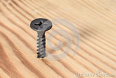 Black screwed into wood Stock Photo