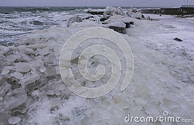 The Black Sea is frozen, the circular ice rolled by the waves is thrown ashore and frozen Stock Photo