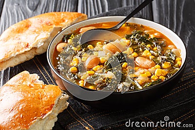 Black Sea Turkish vegetarian Kara lahana corbasÄ± spicy cabbage soup with kale, beans, tomatoes and corn close-up in a bowl. Stock Photo