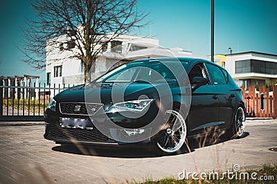 Black Seat Leon FR in Front of high price Houses Editorial Stock Photo