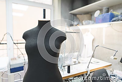 Black sewing mannequin on a background of workplace seamstresses. Sewing concept Stock Photo