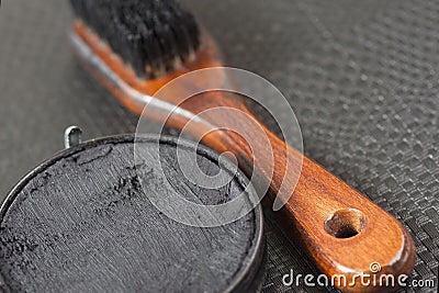 Black shoe shine wax and boot brush. Protecting and impregnate leather shoes Stock Photo