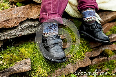 Black shoes with colored socks on child legs Stock Photo