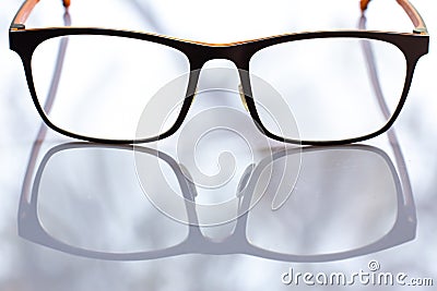 Black shortsighted or nearsighted eyeglasses on white acrylic table background, Close up & Macro shot, Reflection, Optical concept Stock Photo