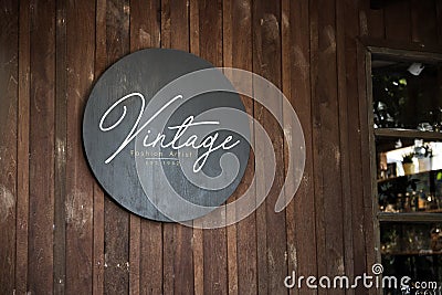 Black sign on a wooden wall mockup Stock Photo