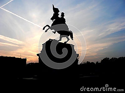 Black silhouette of monument of horse rider on background of rose sunset Stock Photo