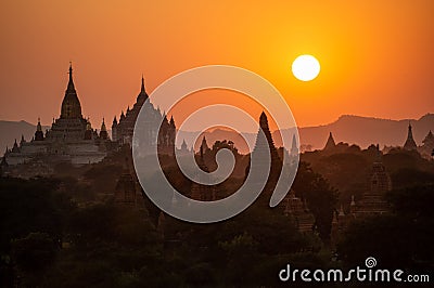 Black silhouettes of temples and trees at sunset at Bagan Stock Photo