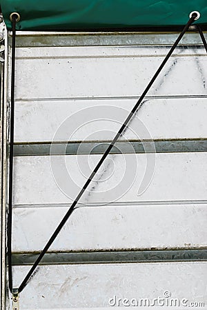 Black single safety link string on white tinware Stock Photo