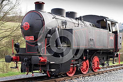 Black single steam locomotive with red wheels. Renovated engine Stock Photo