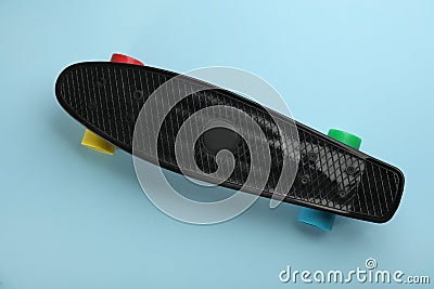 Black skateboard on turquoise background, top view Stock Photo