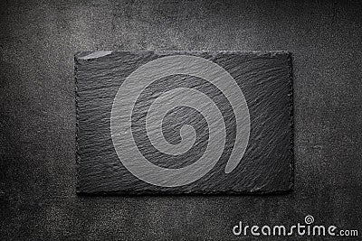 Black slate board on dark stone texture top view. Empty space for menu or recipe Stock Photo