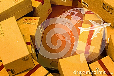 Black smartphone with World map on pile of cardboard boxes. concept of International freight or shipping service for online Stock Photo