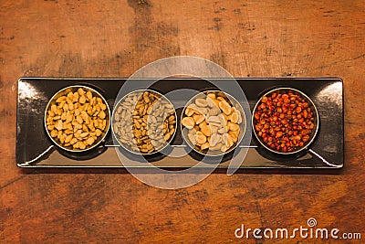 Black snack plate with different types of nuts and seeds 2 Stock Photo