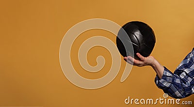 Black soccer ball on bright yellow background with copy space Stock Photo