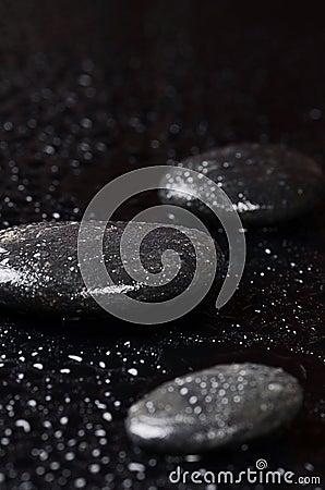 Black spa stones with water drops Stock Photo