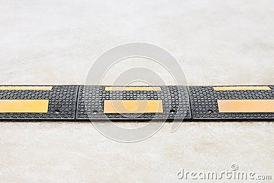Black speed bump on the road close-up Stock Photo