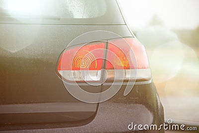 Black sports hatchback car rear light with lens flare coseup Stock Photo