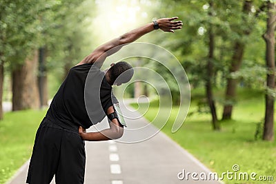 Black sportsman exercising before jogging, back view Stock Photo