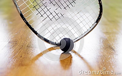 Black squash ball and tennis racket in tennis club Stock Photo