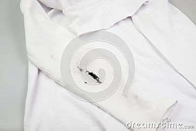 Black stain on white clothes. Dirt on children's clothes Stock Photo