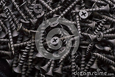 Black steel self-tapping screws used in handicrafts background texture Stock Photo