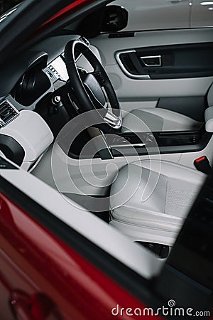 Black steering wheel and grey seats in red automobile. Stock Photo
