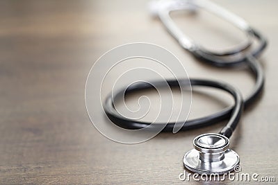 Black Stethoscope on Light Brown Stock Photo