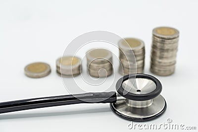 black stethoscope and soft focus of Stacking coins arranged as growth graph Stock Photo