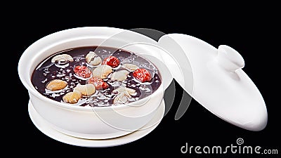 black sticky rice sweet soup. Chinese traditional cuisine isolated on black background Stock Photo