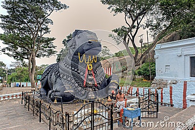 Black stone Nandi bull sits on Chamundi Hill way to Chmudi temple Editorial Stock Photo