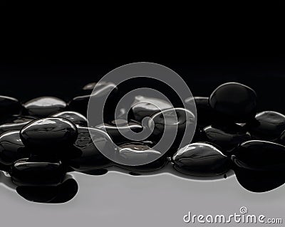 Black stones on calm water Stock Photo