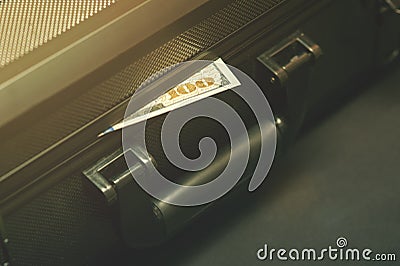 Black suitcase with dollars Stock Photo