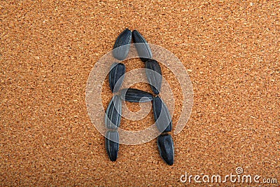 Black Sunflower Seeds Alphabet wooden background Stock Photo