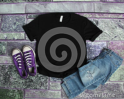 Black T Shirt mockup flat lay on purple brick background with pu Stock Photo