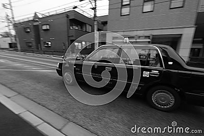 Black taxi driving fast in a street Editorial Stock Photo