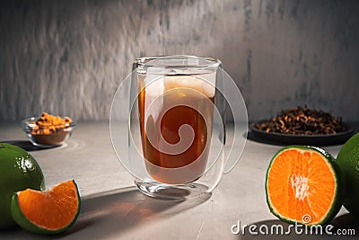 Black tea with green Mandarin oil in a double-walled glass Stock Photo