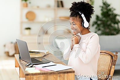 Black Teen Girl Studying At Laptop Online Sitting At Home Stock Photo