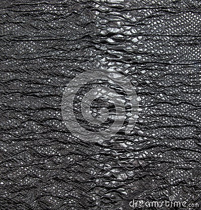 Black textured crinkled background. Black wrinkled fabric with lace inserts Stock Photo