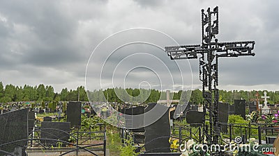 Black tombstone metal cross in the city cemetery. City geaveyard Editorial Stock Photo