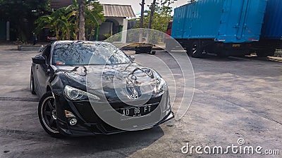 Black Toyota GT86 ir Toyota 86 drifting on a closed parking lot taken from front view Editorial Stock Photo