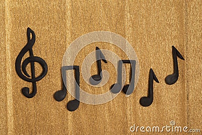 Black treble clef and music notes on golden background. Violin key. Key of G. Music symbol Stock Photo