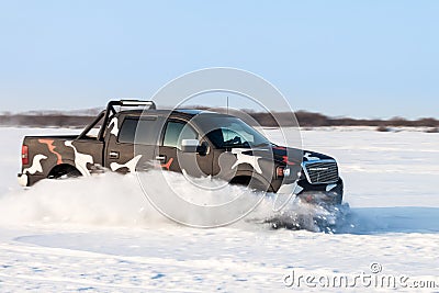 Black truck motion blurred while moving fast on snow Stock Photo