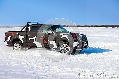 Black truck moving fast on snow Stock Photo