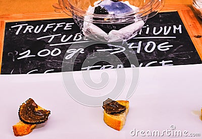 Black truffle slice, on piece of toasted bagette Stock Photo