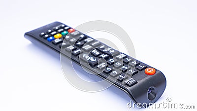 A black tv remote is isolated on white background. Stock Photo