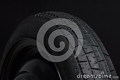 Black Tyre in Black background Stock Photo