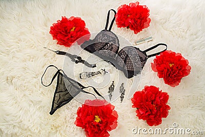 Black underwear knickers and bra in gliter perfume flowers juwelery on white background Stock Photo